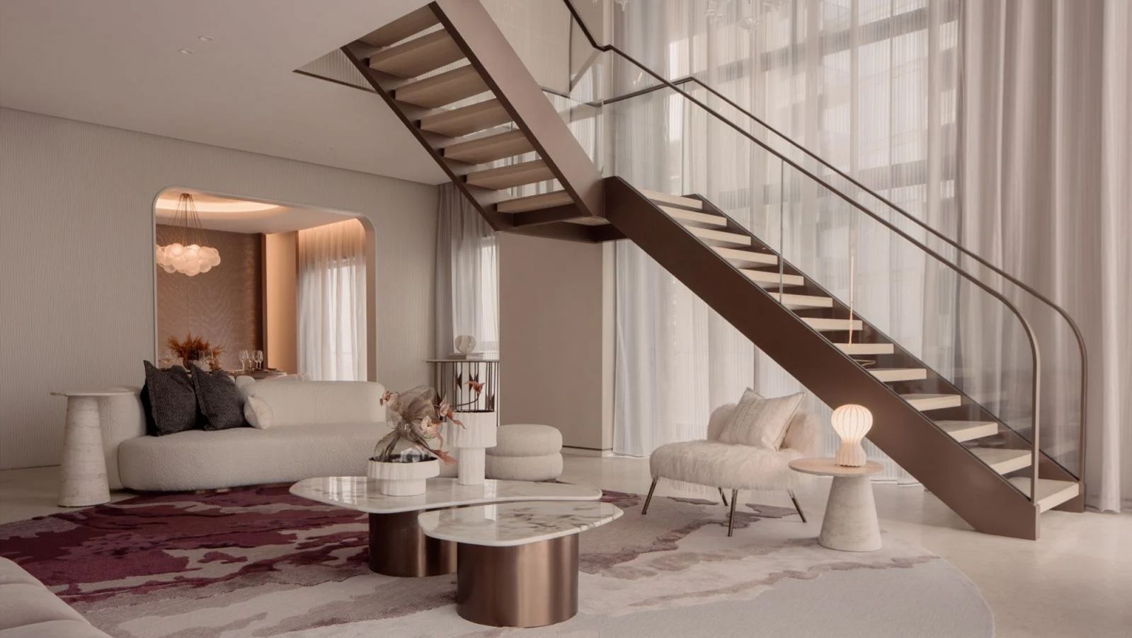 The super penthouse’s living area is decked out in peach, soft pink, and rose-gold tones